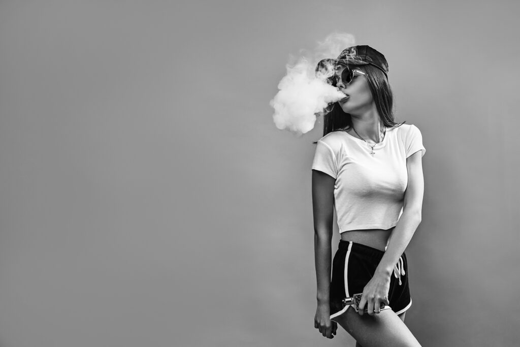 seductive-glamour-young-woman-standing-vaping-pink